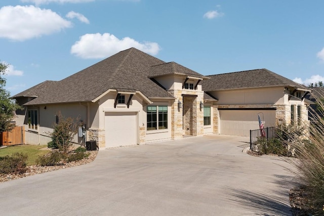 18201 Hewetson Cv, Austin, TX 78738 - view of front of house featuring stone siding, stucco siding, a garage, and concrete driveway