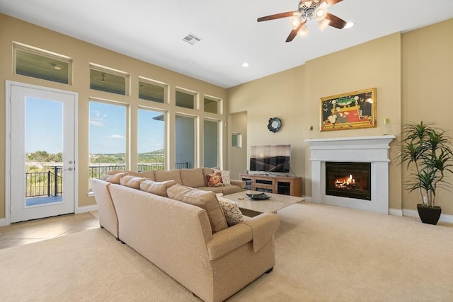 18201 Hewetson Cv, Austin, TX 78738 - living room featuring ceiling fan, a glass covered fireplace, baseboards, light colored carpet, and recessed lighting