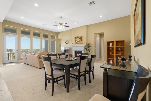 18201 Hewetson Cv, Austin, TX 78738 - dining area featuring light carpet, a warm lit fireplace, a ceiling fan, recessed lighting, and baseboards