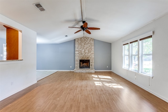 unfurnished living room with light wood-type flooring, lofted ceiling, ceiling fan, and a fireplace