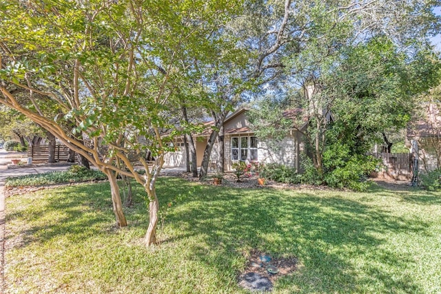 obstructed view of property featuring a front yard