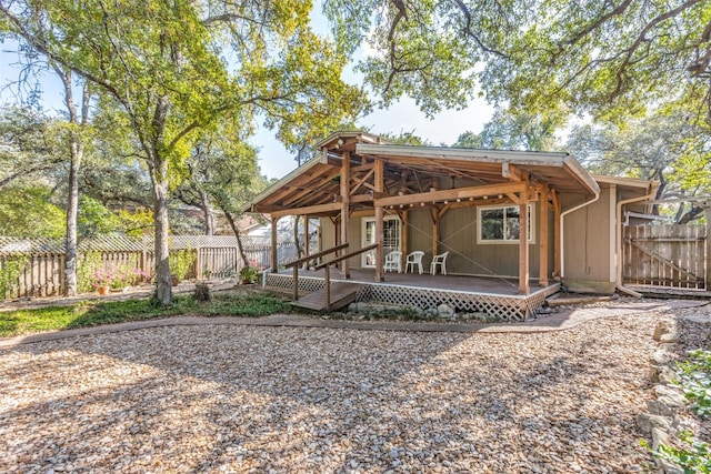 back of house featuring a deck