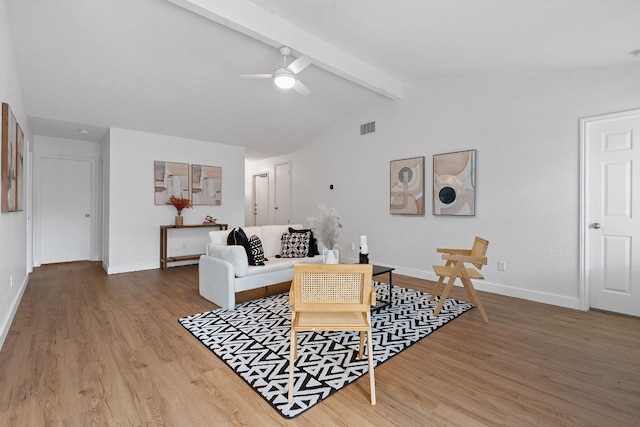 living room featuring hardwood / wood-style floors, vaulted ceiling with beams, and ceiling fan