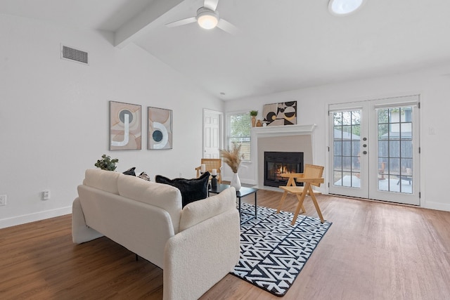 living room with french doors, hardwood / wood-style floors, lofted ceiling with beams, and ceiling fan