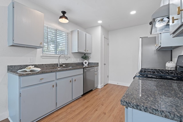 kitchen featuring dishwasher, sink, gray cabinets, light wood-type flooring, and range hood