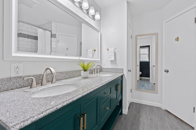 bathroom featuring hardwood / wood-style floors, vanity, and curtained shower