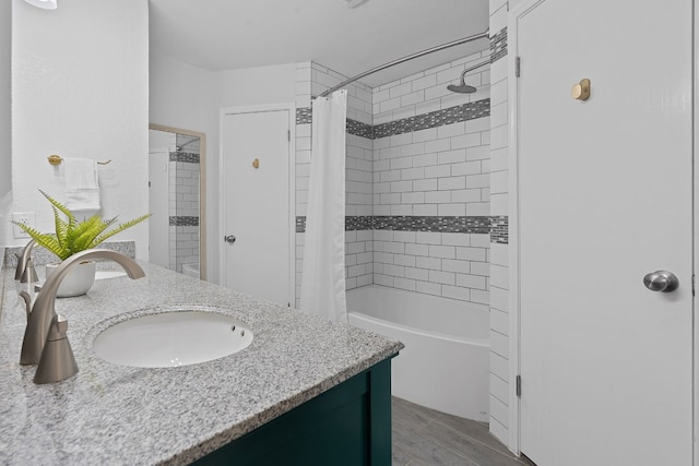 bathroom featuring shower / bath combo with shower curtain, vanity, and wood-type flooring