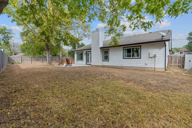 rear view of property with a yard and a patio