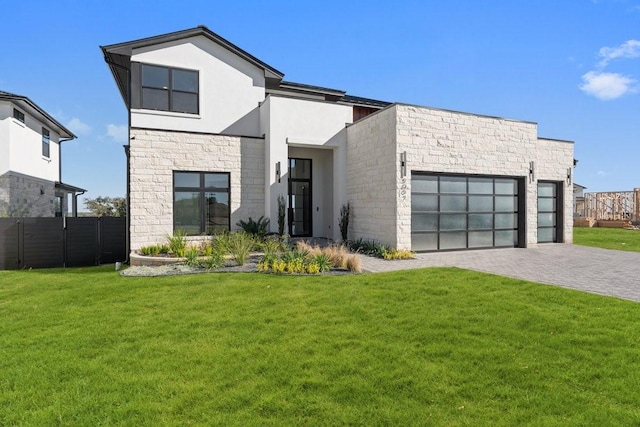 contemporary home with a front yard and a garage