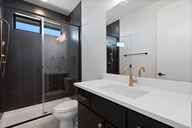 bathroom featuring vanity, toilet, and walk in shower