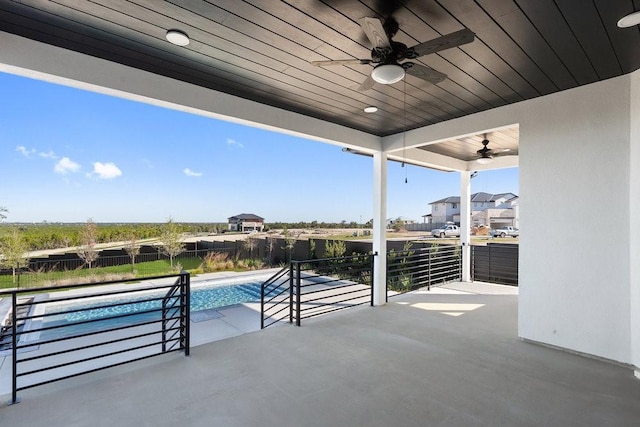 view of patio with a fenced in pool and ceiling fan