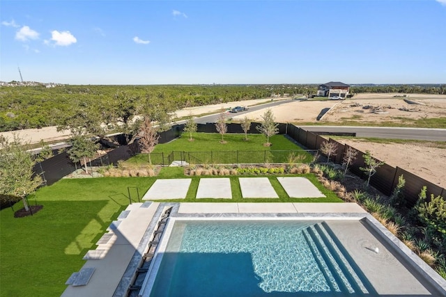 view of pool with a lawn and a fenced backyard