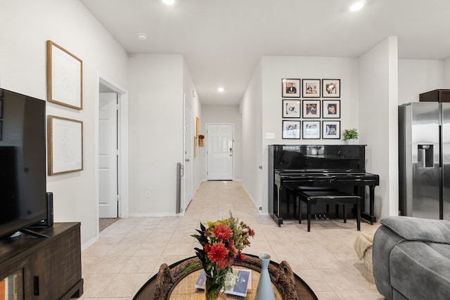 living room featuring light tile patterned floors, baseboards, and recessed lighting