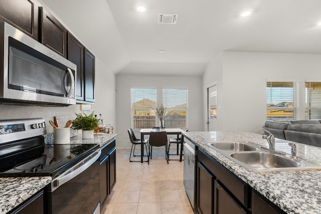 kitchen with stainless steel appliances, recessed lighting, visible vents, a sink, and dark brown cabinets