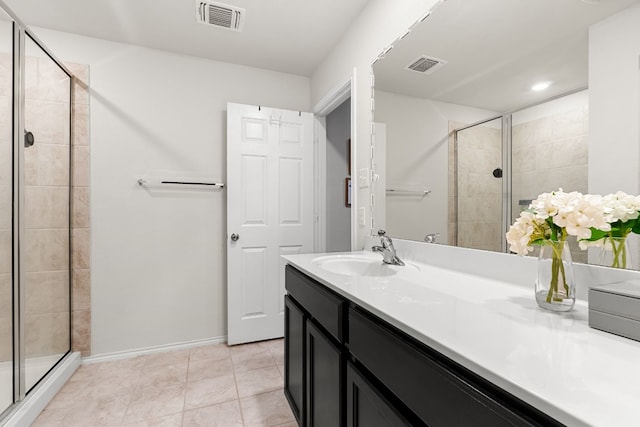 full bath featuring tile patterned flooring, visible vents, a shower stall, and vanity