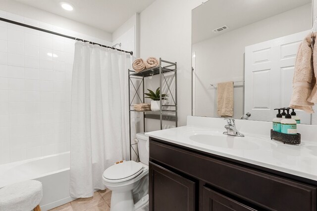 bathroom featuring shower / bath combination with curtain, visible vents, toilet, vanity, and tile patterned floors