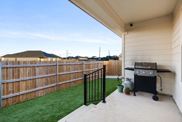 view of patio with grilling area and a fenced backyard