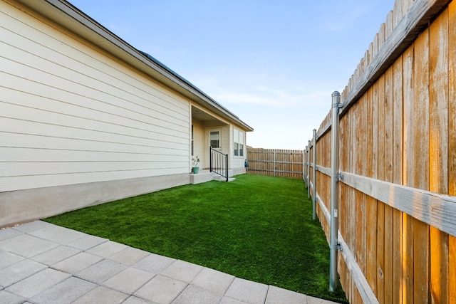 view of yard featuring a patio area and a fenced backyard