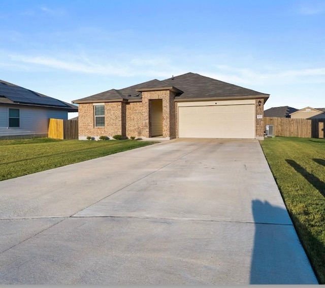 view of front of house featuring a garage, fence, concrete driveway, and a front yard