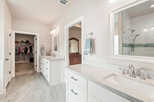 bathroom with a shower with door and vanity