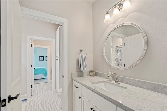 bathroom featuring vanity, toilet, and tile patterned floors