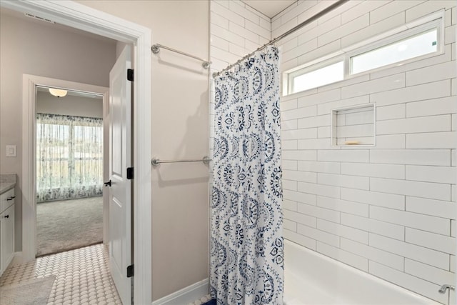 bathroom featuring shower / bath combo with shower curtain, vanity, and tile patterned flooring