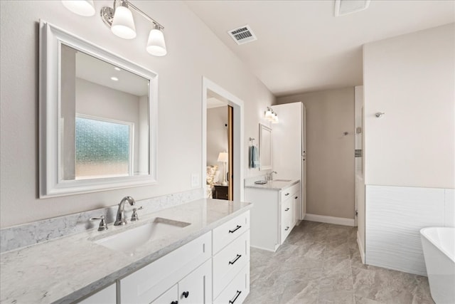 bathroom with vanity and a bathing tub