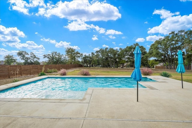 view of pool featuring a yard and a patio