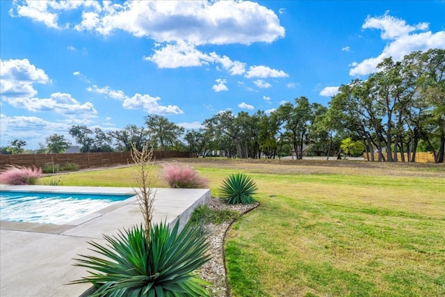 view of pool featuring a lawn