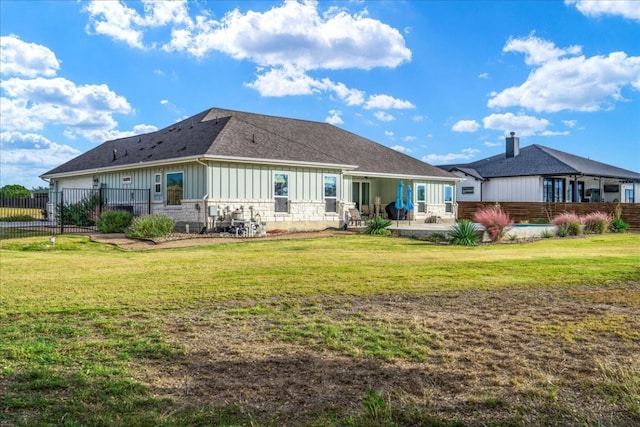 back of house with a lawn