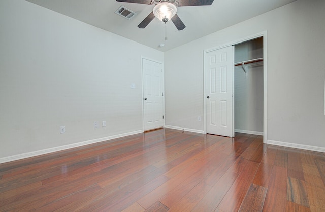 unfurnished bedroom featuring a closet, ceiling fan, and dark hardwood / wood-style floors