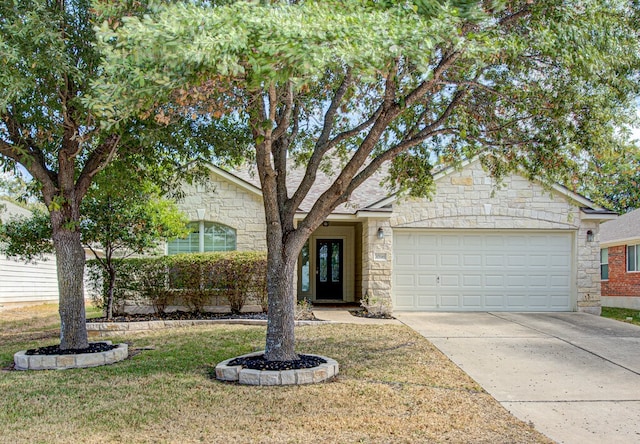 view of front of house with a front yard and a garage