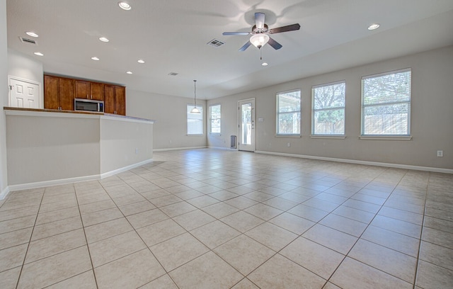 unfurnished living room with ceiling fan and light tile patterned floors