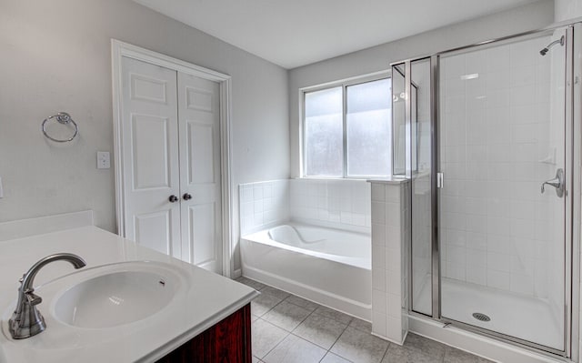 bathroom featuring vanity, shower with separate bathtub, and tile patterned flooring