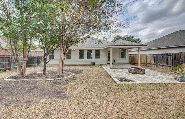 view of front of property with a front lawn, a patio, and a fire pit