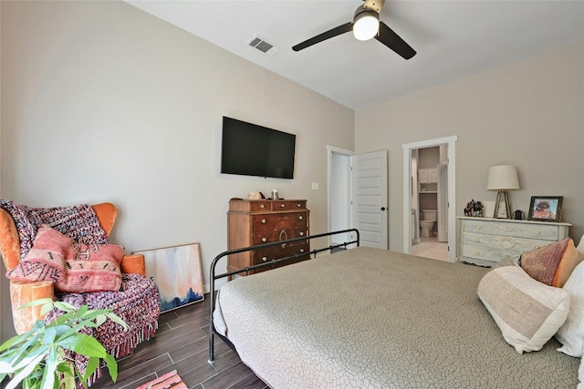 bedroom featuring ceiling fan, dark hardwood / wood-style flooring, a walk in closet, and a closet