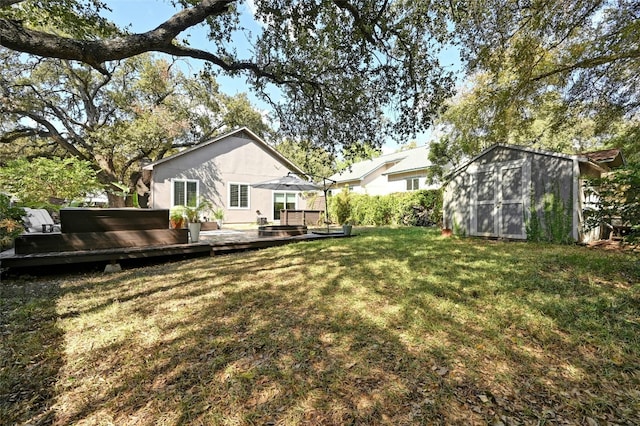 view of yard with a shed and a wooden deck