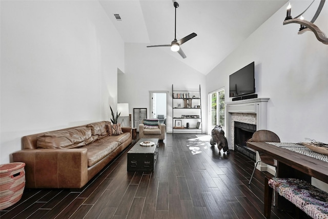 living room featuring ceiling fan, high vaulted ceiling, and dark wood-type flooring