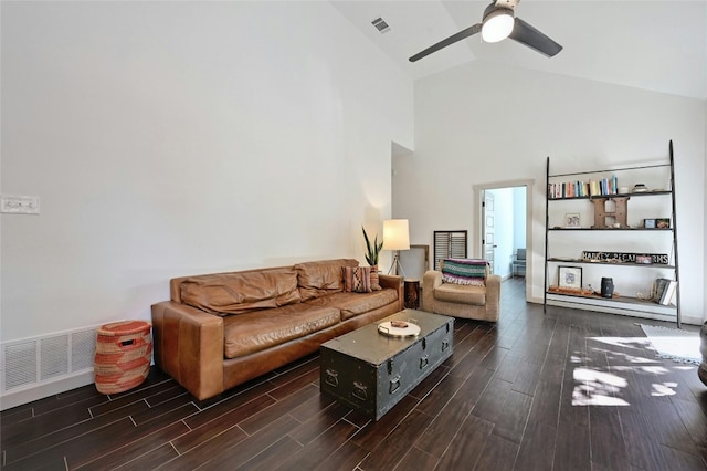 living room featuring ceiling fan, dark hardwood / wood-style flooring, and high vaulted ceiling