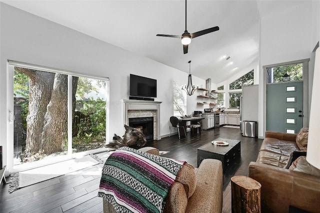 living room featuring ceiling fan with notable chandelier, dark hardwood / wood-style flooring, high vaulted ceiling, and plenty of natural light