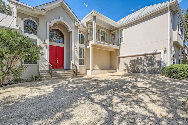 view of front of house featuring a garage and a balcony