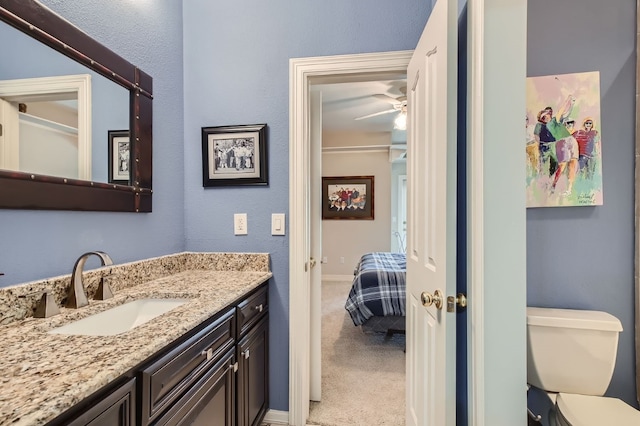 bathroom featuring toilet and vanity