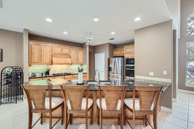 kitchen with appliances with stainless steel finishes, sink, ceiling fan, light tile patterned floors, and ventilation hood