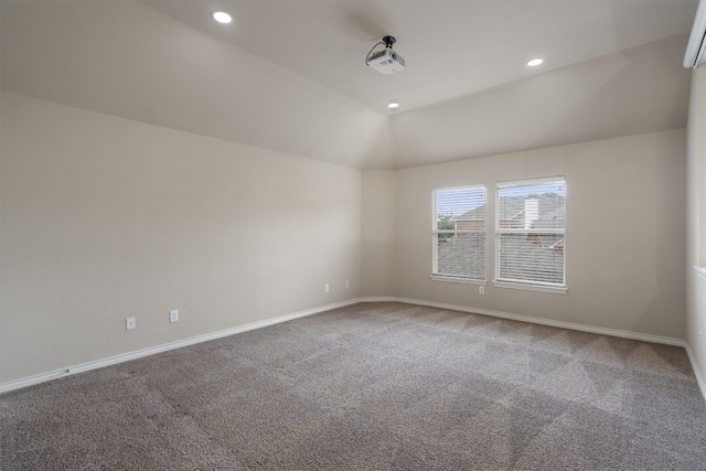 spare room featuring vaulted ceiling and carpet