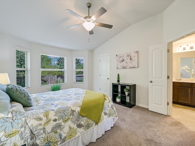 bedroom featuring connected bathroom, light carpet, vaulted ceiling, and ceiling fan