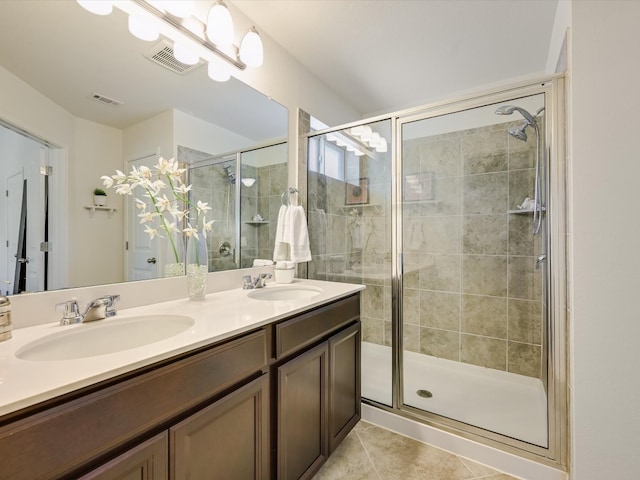 bathroom with vanity, walk in shower, and tile patterned flooring