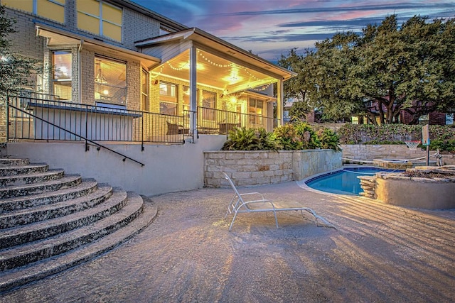 outdoor pool featuring stairway and a patio area