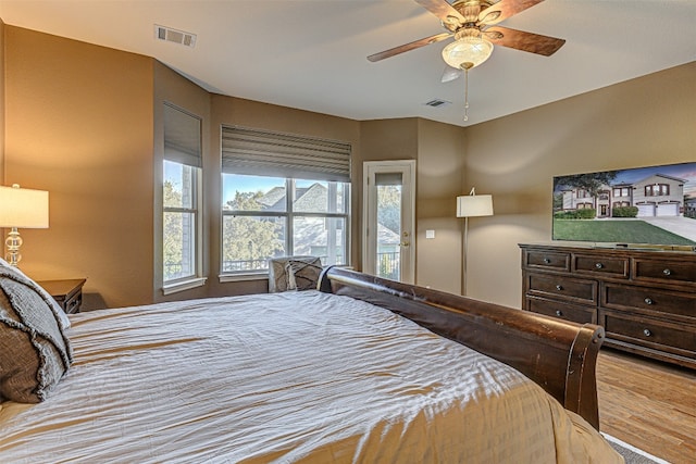 bedroom with light hardwood / wood-style floors and ceiling fan