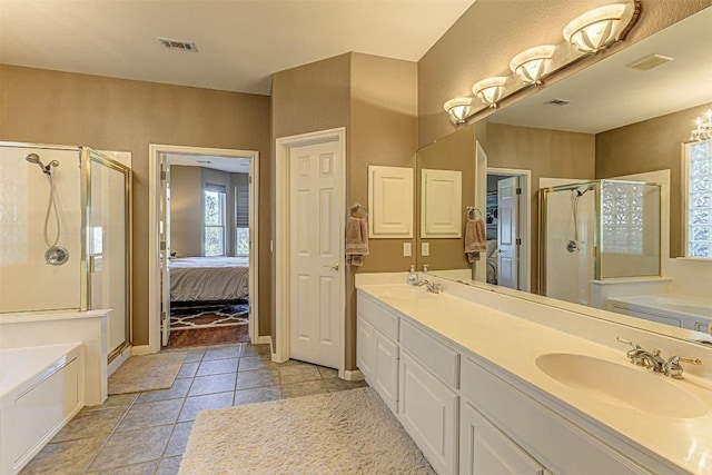 bathroom with visible vents, double vanity, a stall shower, a bath, and a sink