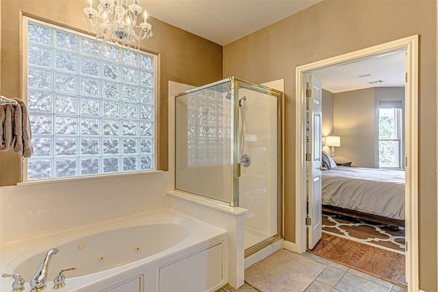 bathroom with tile patterned floors, a jetted tub, a stall shower, and ensuite bathroom